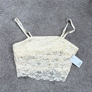 Cream lace crop top with adjustable straps. Size: L